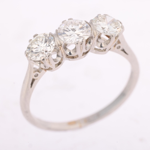 1326 - A platinum three stone diamond ring, claw set with modern round brilliant and transitional-cut diamo... 