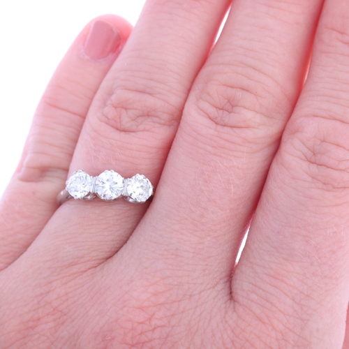 1326 - A platinum three stone diamond ring, claw set with modern round brilliant and transitional-cut diamo... 