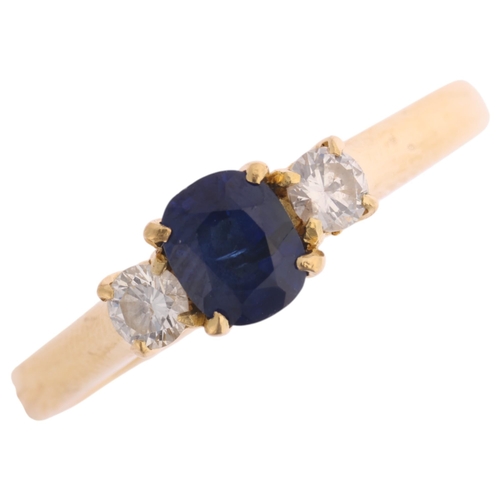 1349 - An 18ct gold three stone sapphire and diamond ring, indistinct hallmarks, set with 0.55ct oval cushi... 