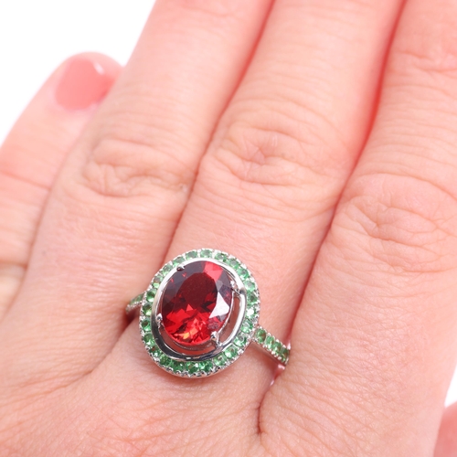 1368 - An 18ct white gold Mozambique garnet and chrome diopside halo cluster ring, claw set with oval mixed... 