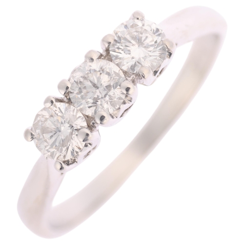 1370 - A platinum three stone diamond ring, maker JSN, claw set with modern round brilliant-cut diamonds, t... 