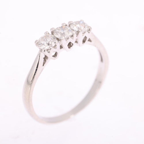 1370 - A platinum three stone diamond ring, maker JSN, claw set with modern round brilliant-cut diamonds, t... 