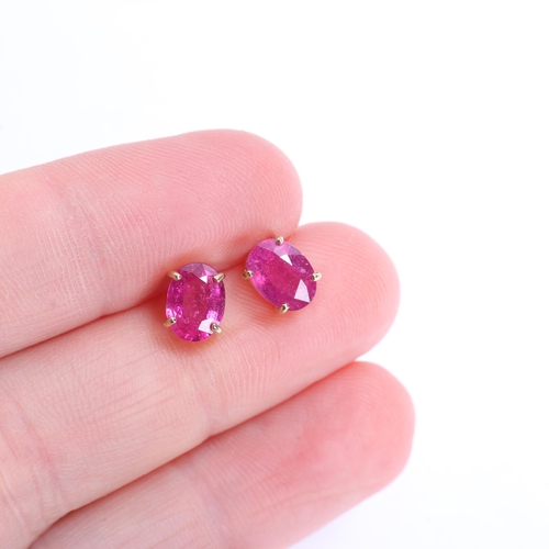 1381 - A pair of 9ct gold single stone ruby stud earrings, claw set with oval mixed-cut rubies, 7.4mm, 1.3g
