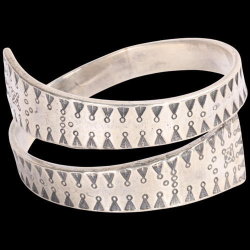 1583 - FIRMA KOPI - a Danish sterling silver Viking Revival wrap-around torque bangle, overall setting heig... 