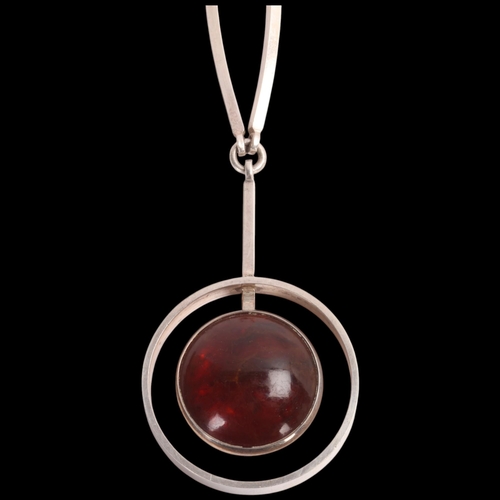 1607 - NIELS ERIK FROM - a Danish modernist sterling silver amber openwork pendant necklace, on integral st... 