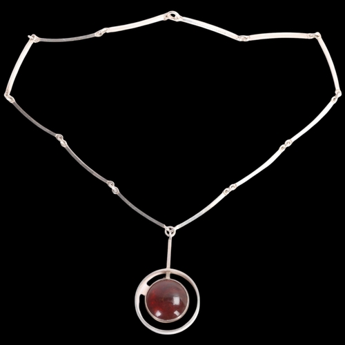 1607 - NIELS ERIK FROM - a Danish modernist sterling silver amber openwork pendant necklace, on integral st... 