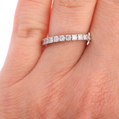 1380 - A platinum diamond half eternity ring, claw set with modern round brilliant-cut diamonds, total diam... 