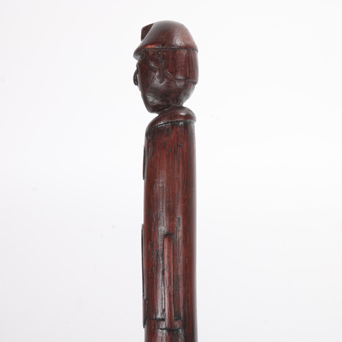 308 - A one-piece Folk Art colliers’ cane, the top carved as a helmeted miner's head with nails for eyes a... 