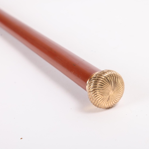 312 - An Antique gilt metal handled with spiral design walking cane, Malacca shaft painted a deep shade of... 