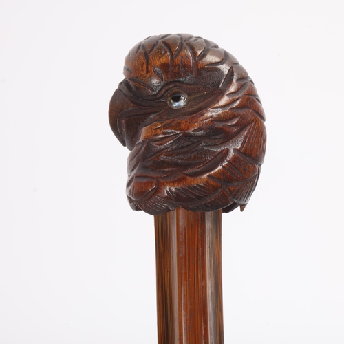 319 - A well-carved parrot head handle cane with inset glass eyes and dark beak, on a later unusually shap... 