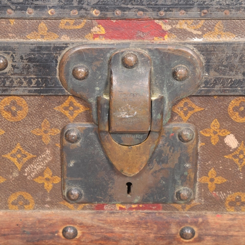330A - LOUIS VUITTON - a Vintage monogram steamer trunk, brass furniture, lined interior and original label... 