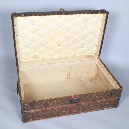 330A - LOUIS VUITTON - a Vintage monogram steamer trunk, brass furniture, lined interior and original label... 