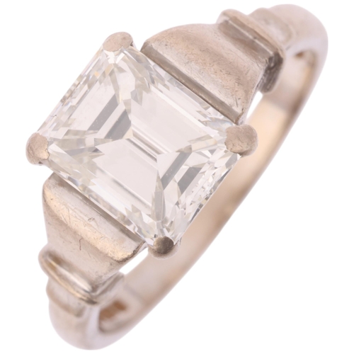 1117 - An 18ct white gold 2ct single stone emerald-cut diamond ring, maker BKT, London 1990, claw set with ... 