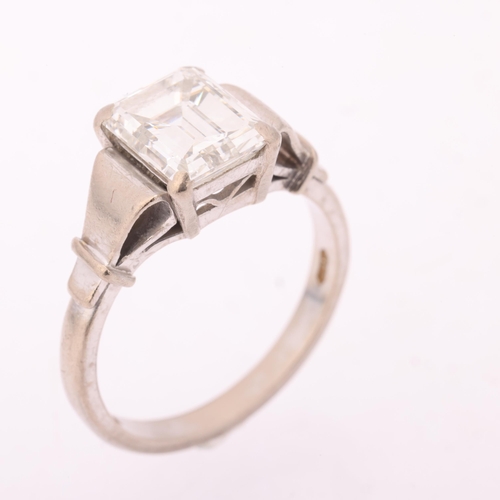 1117 - An 18ct white gold 2ct single stone emerald-cut diamond ring, maker BKT, London 1990, claw set with ... 