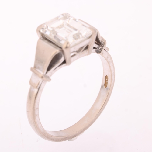 1117 - An 18ct white gold 2ct single stone emerald-cut diamond ring, maker BKT, London 1990, claw set with ... 
