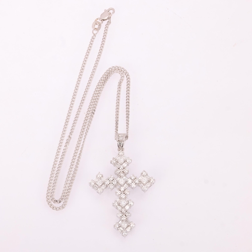 1134 - An 18ct white gold diamond cross pendant necklace, set with Princess baguette and modern round brill... 