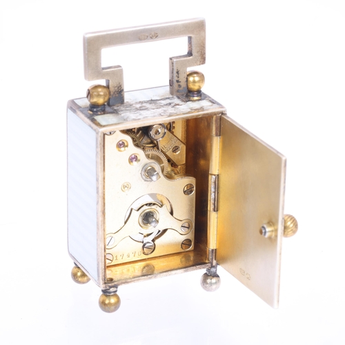 1062 - An Art Deco sterling silver-gilt white enamel miniature carriage clock, circa 1910, white dial with ... 