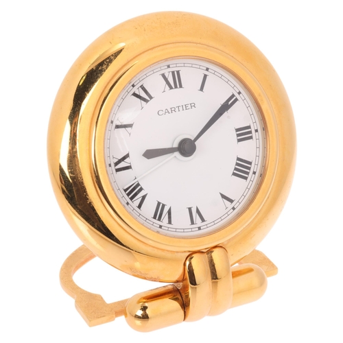 1064 - CARTIER - a gilt-metal 'Colisee' quartz alarm desk clock, round white dial with black Roman numeral ... 