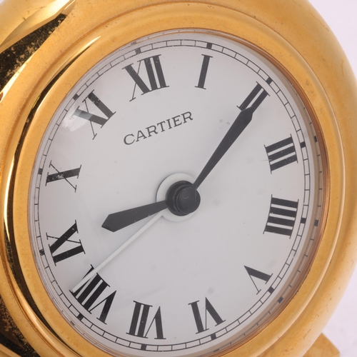 1064 - CARTIER - a gilt-metal 'Colisee' quartz alarm desk clock, round white dial with black Roman numeral ... 