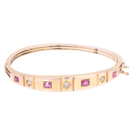 1105 - An Antique Victorian 9ct rose gold seven stone ruby and diamond hinged bangle, circa 1900, set with ... 