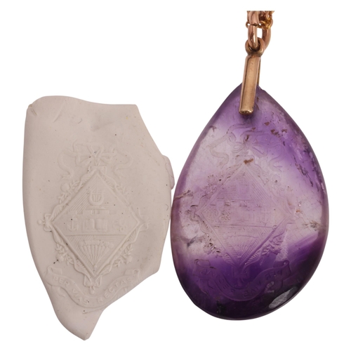 1108 - An Antique amethyst armorial intaglio pendant necklace, the polished teardrop amethyst pebble intagl... 