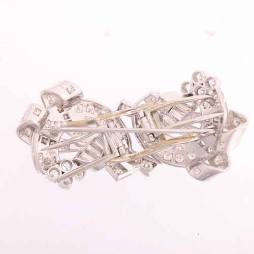 1112 - A Retro platinum diamond double-clip brooch, circa 1950, scrolling ribbon form, each clip detachable... 