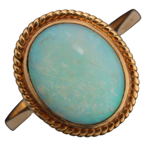 1115 - A 14ct gold opal dress ring, rub-over set with 1ct oval cabochon opal, in rope twist surround, setti... 