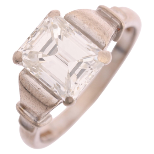 1117 - An 18ct white gold 2ct single stone emerald-cut diamond ring, maker BKT, London 1990, claw set with ... 