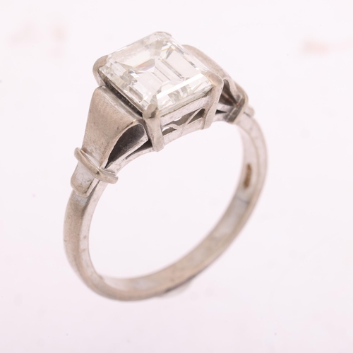 1117 - An 18ct white gold 2ct single stone emerald-cut diamond ring, maker BKT, London 1990, claw set with ... 