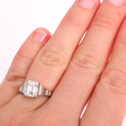 1117 - An 18ct white gold 2ct single stone emerald-cut diamond ring, maker BKT, London 1990, claw set with ... 