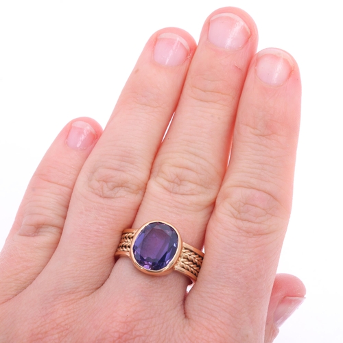 1125 - A Continental 18ct gold single stone synthetic sapphire dress ring, rub-over set with oval-cut synth... 