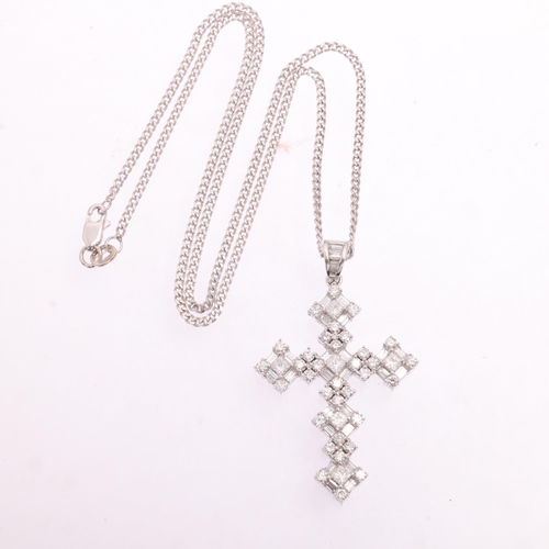 1134 - An 18ct white gold diamond cross pendant necklace, set with Princess baguette and modern round brill... 