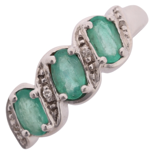 1200 - A 9ct white gold emerald and diamond half hoop ring, set with oval mixed-cut emeralds and single-cut... 