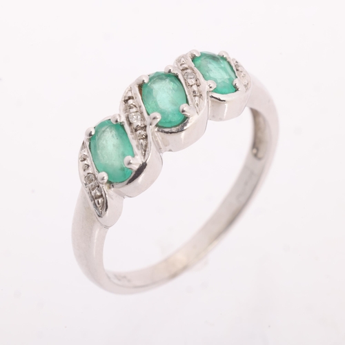 1200 - A 9ct white gold emerald and diamond half hoop ring, set with oval mixed-cut emeralds and single-cut... 