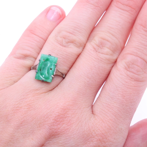 1203 - A Chinese 9ct gold jade panel ring, setting height 13.1mm, size K, 1.6g