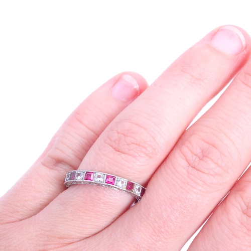 1215 - A 9ct white gold ruby and cubic zirconia full eternity ring, Charles Green & Son Ltd, Birmingham 196... 