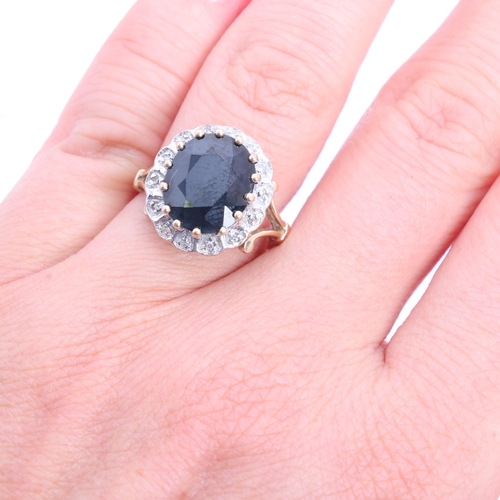 1216 - A 9ct gold sapphire and diamond cluster ring, claw set with oval mixed-cut sapphire and single-cut d... 
