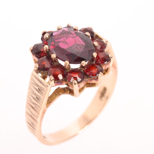 1220 - A Vintage 9ct gold garnet flowerhead cluster ring, maker G&TJ, London 1978, with textured shoulders,... 