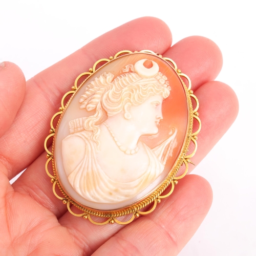 1239 - A Vintage 9ct gold shell cameo brooch, the oval panel relief carved depicting Nyx, Goddess of Night,... 
