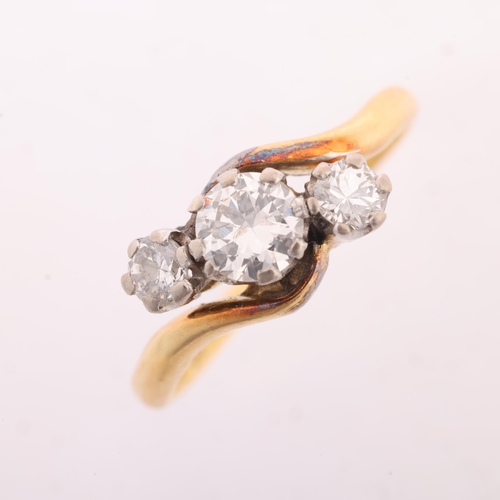 1243 - An Antique 18ct gold three stone diamond crossover ring, claw set with round transitional-cut diamon... 