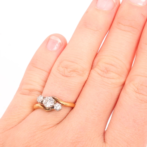 1243 - An Antique 18ct gold three stone diamond crossover ring, claw set with round transitional-cut diamon... 