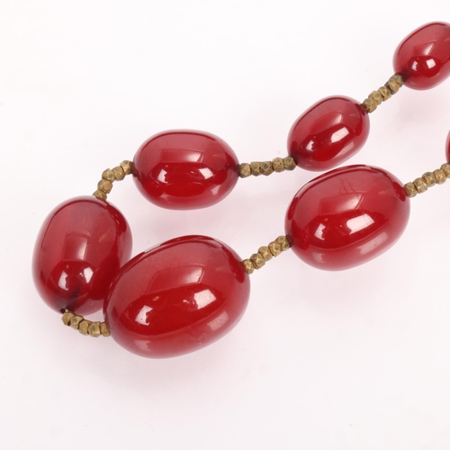 1256 - A Vintage single-row graduated cherry amber bead necklace, amber measures 20.7-9.3mm, 60cm, 27.4g