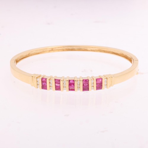 1133 - A 14ct gold ruby and diamond half hoop hinged bangle, bar set with rectangular step-cut rubies and m... 