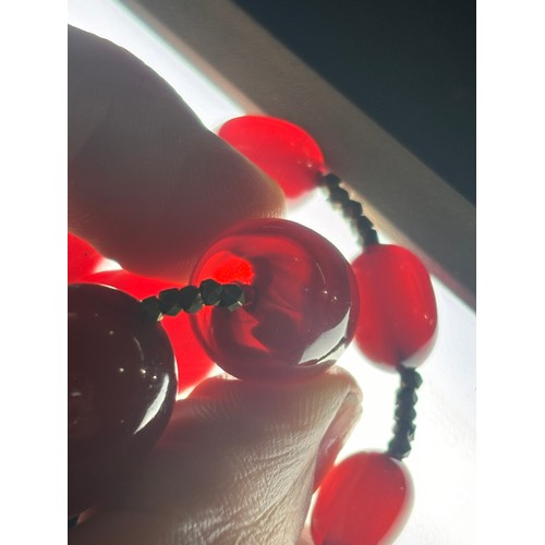 1256 - A Vintage single-row graduated cherry amber bead necklace, amber measures 20.7-9.3mm, 60cm, 27.4g
