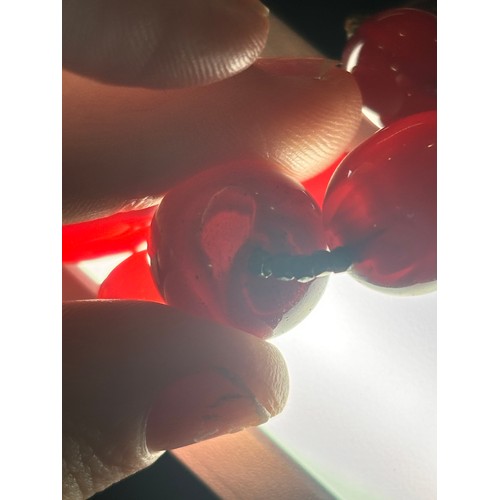 1256 - A Vintage single-row graduated cherry amber bead necklace, amber measures 20.7-9.3mm, 60cm, 27.4g