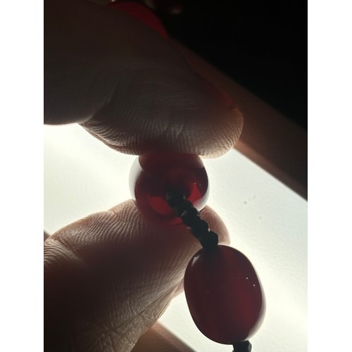 1256 - A Vintage single-row graduated cherry amber bead necklace, amber measures 20.7-9.3mm, 60cm, 27.4g