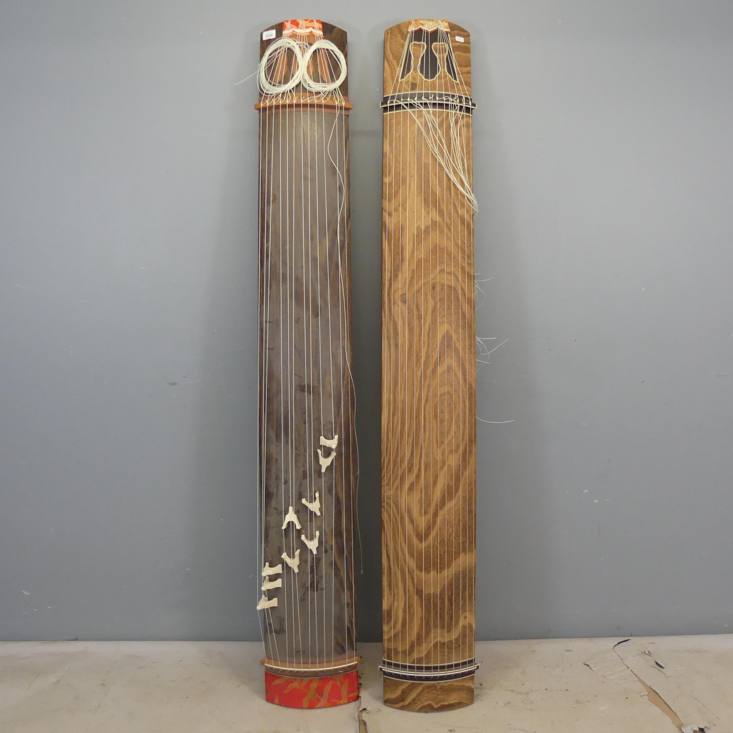 Two Japanese Koto instruments. Length 186cm.