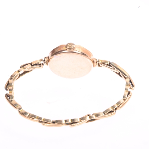 1029 - A lady's 9ct rose gold mechanical bracelet watch, gilt dial with black Arabic numerals, blued steel ... 