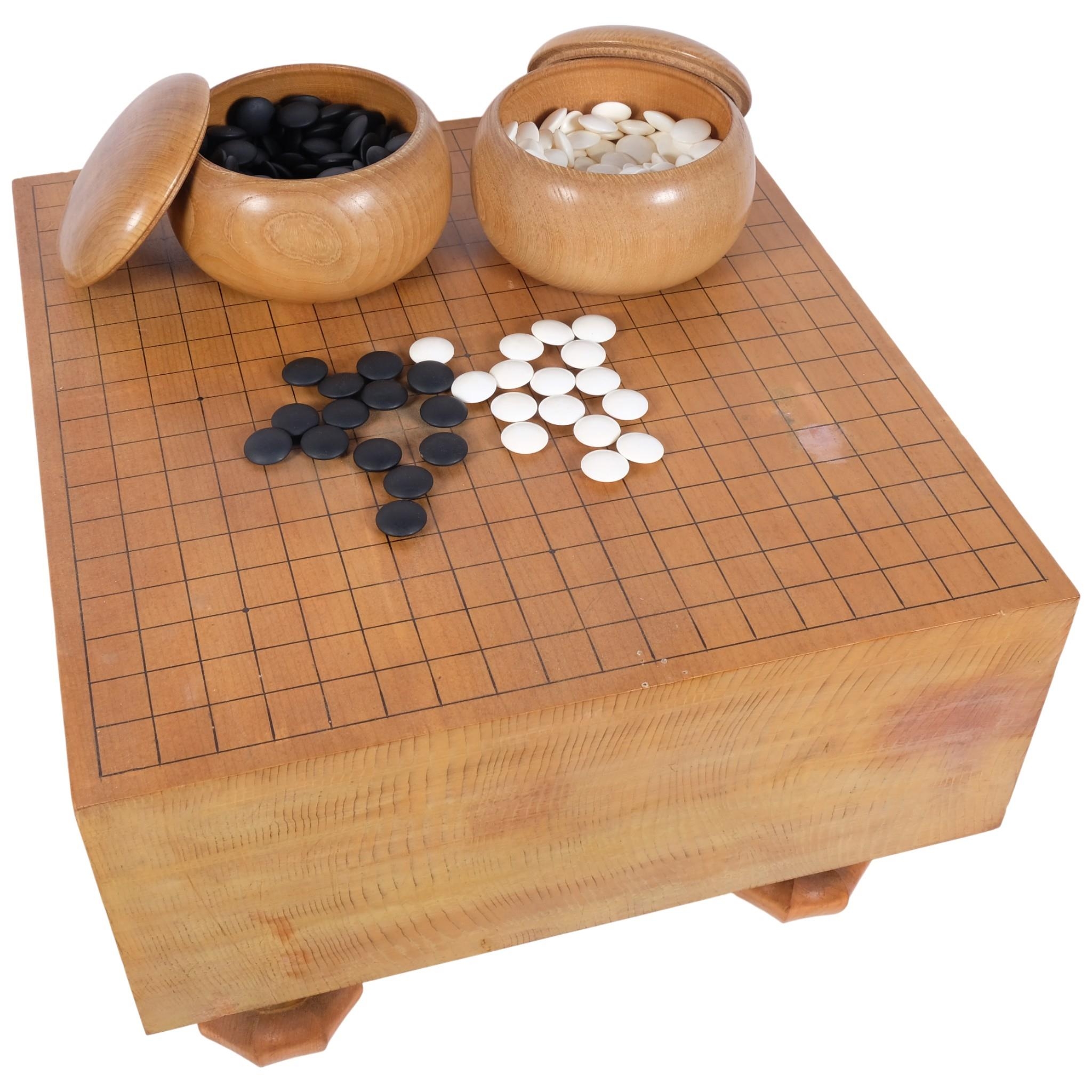 A Japanese Go Board table, with boxed set of counters, 41.5cm across