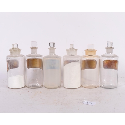 A set of 6 clear glass apothecary bottles, with stoppers and gold ...